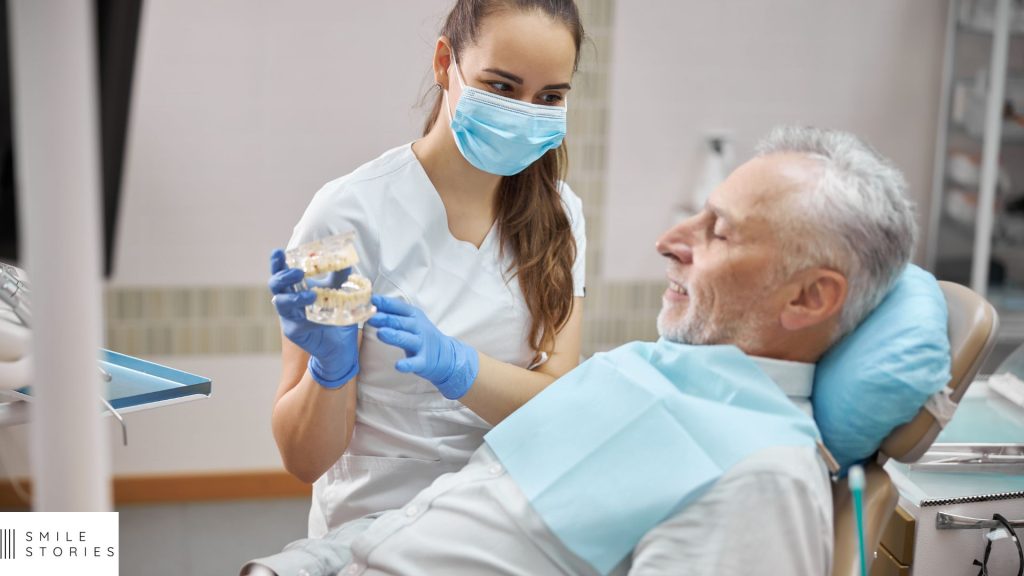 older white male being shown all-on-6 dental implants by a female dentist