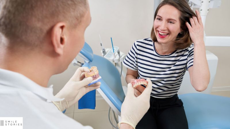 male dentist showing a young female dental implants in Weymouth
