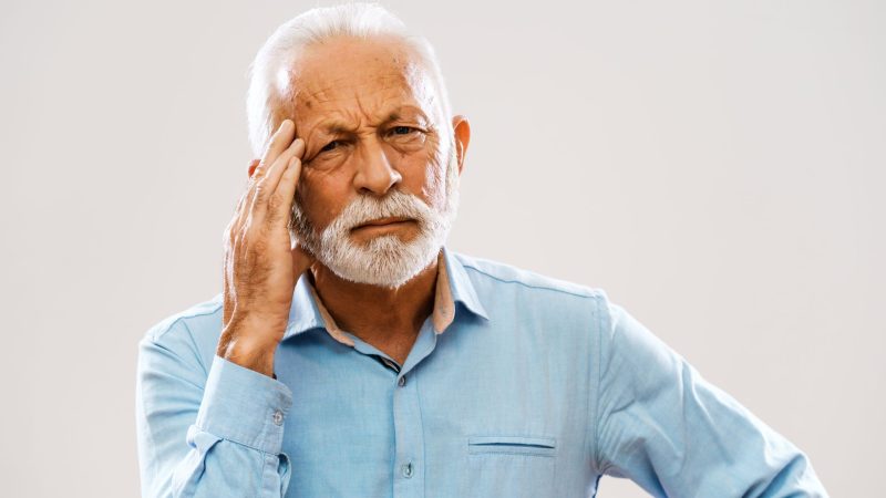 senior worried about his loose dental implant