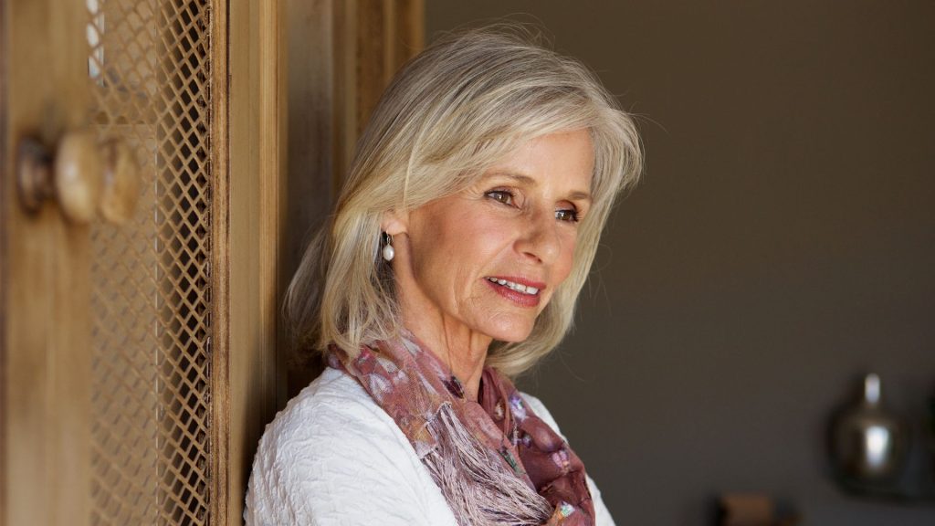 older lady smiling after transforming her smile with all-on-4 dental implants